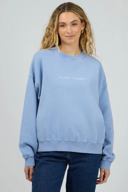 Model wears a light blue crewneck long sleeve jumper