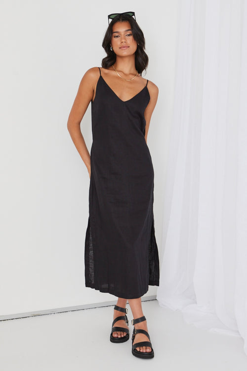 model wears black linen midi dress and black sandals