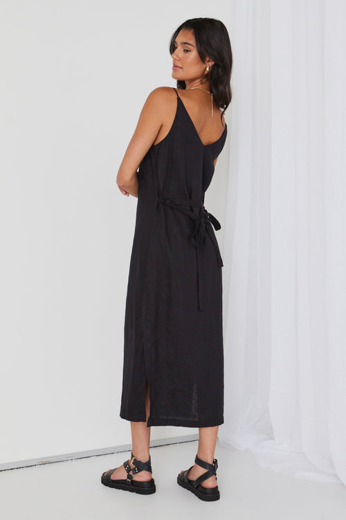 model wears black linen midi dress and black sandals