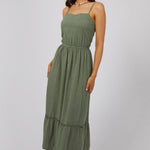 model wears a green maxi dress