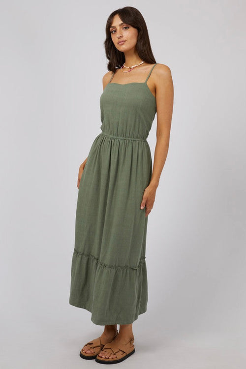 model wears a green maxi dress