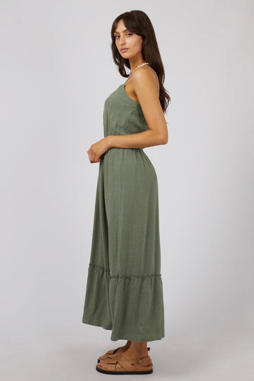 model wears a green maxi dress