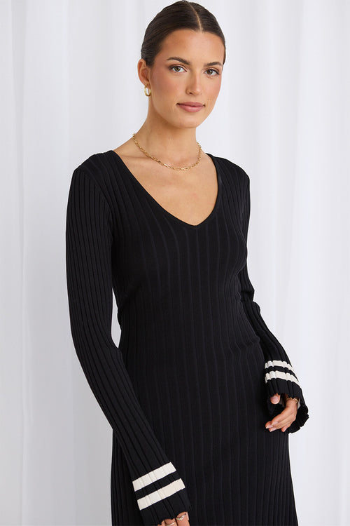 Model wears a long sleeve black maxi dress