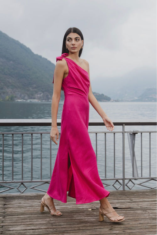 model wears a one shoulder pink midi dress