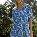 Woman wears a blue white mini smock dress