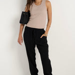 model wears black pant with pockets and drawstring