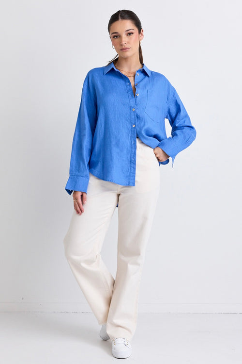 model wears a blue linen shirt