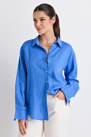 model wears a blue linen shirt