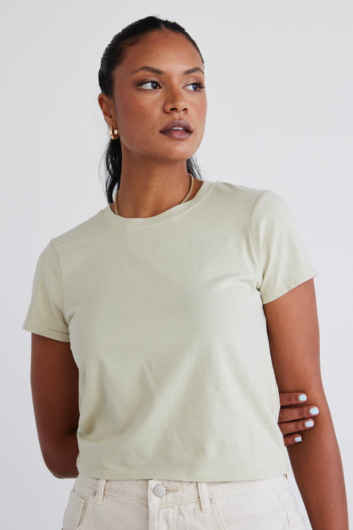 model wears a sage green top