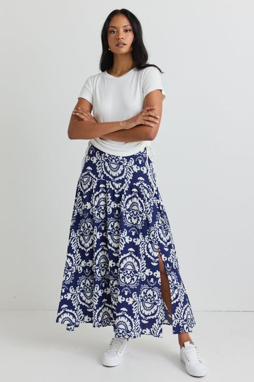 model wears a blue print maxi skirt