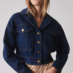 model wears a blue denim jacket