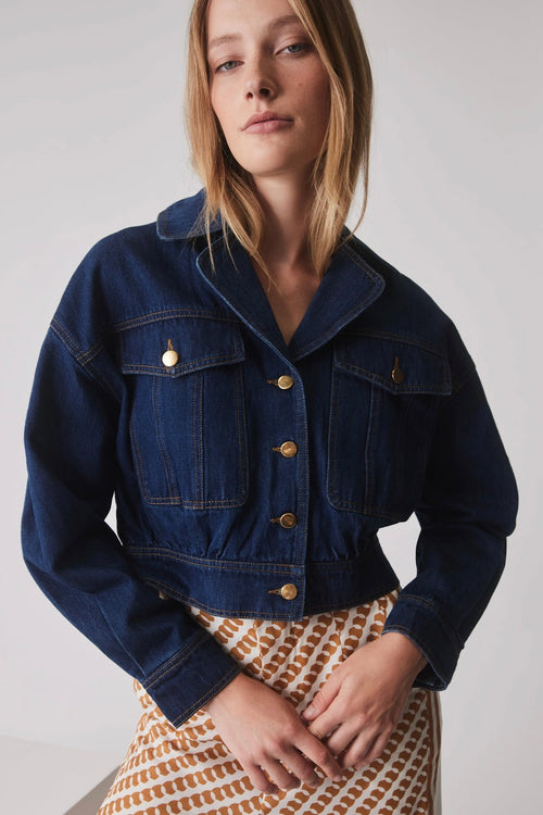 model wears a blue denim jacket