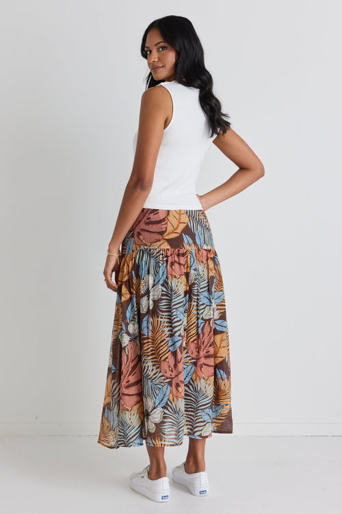 model wears a brown floral maxi skirt