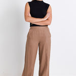 model wears brown linen pants