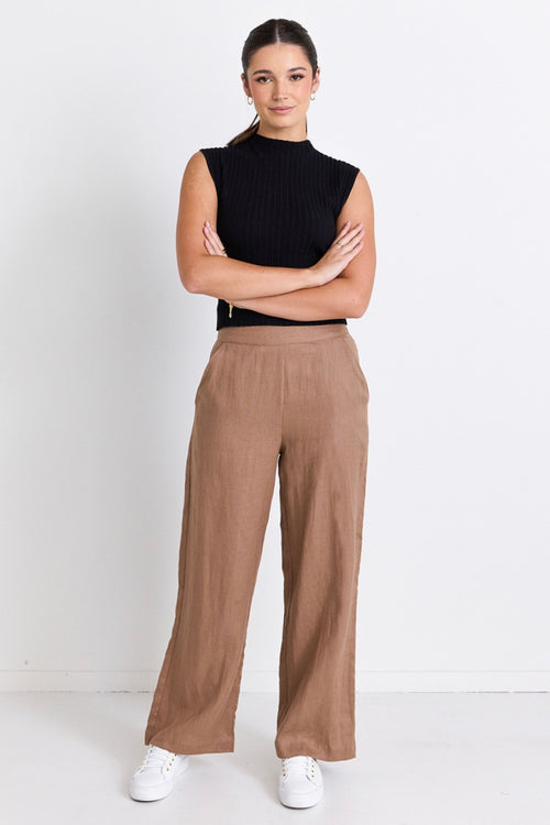 model wears brown linen pants