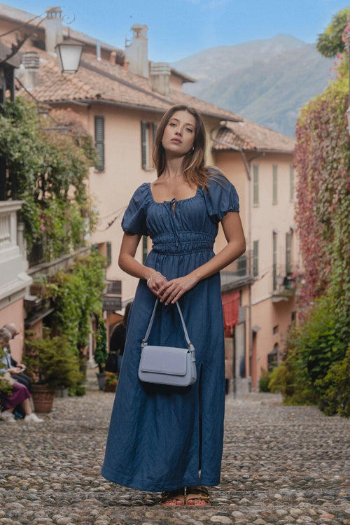 model wears a blue maxi dress