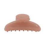 A translucent peach-colored hair claw clip on a solid white background.