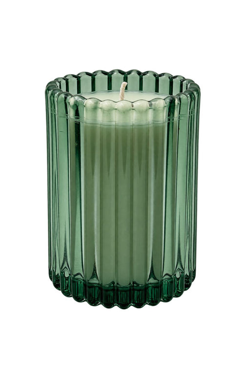 A green ribbed glass candle holder containing a light green candle, shown against a plain white background.