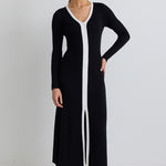 model wears a black knit maxi dress