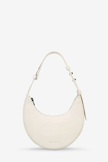 White handbag on a light beige background