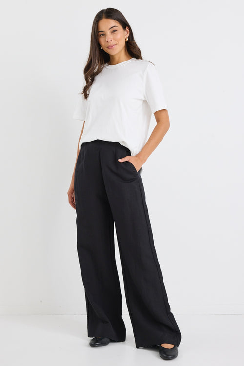model wears a black linen wide leg pant and a white t-shirt