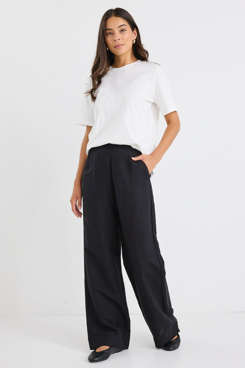 model wears a black linen wide leg pant and a white t-shirt