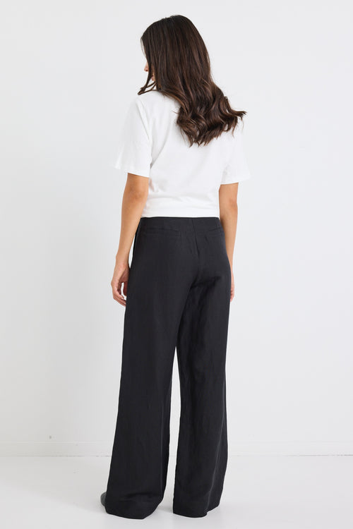 model wears a black linen wide leg pant and a white t-shirt