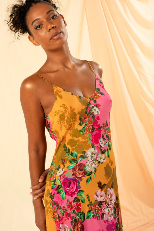 model wears a pink orange floral dress