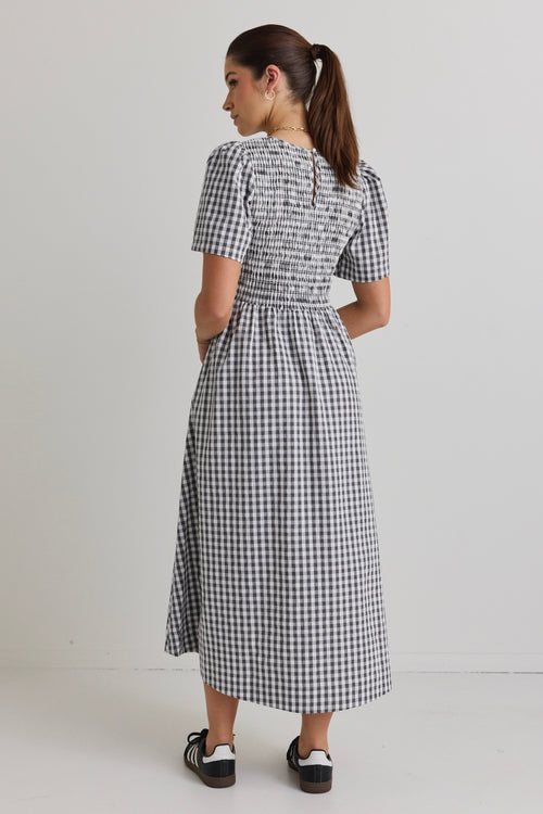  model wears a black gingham midi dress