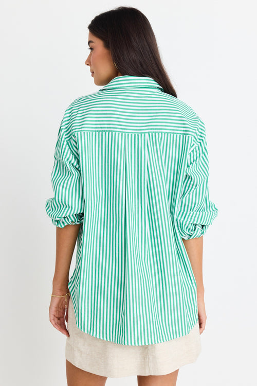 model wears a green stripe shirt