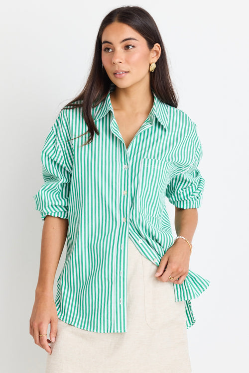 model wears a green stripe shirt